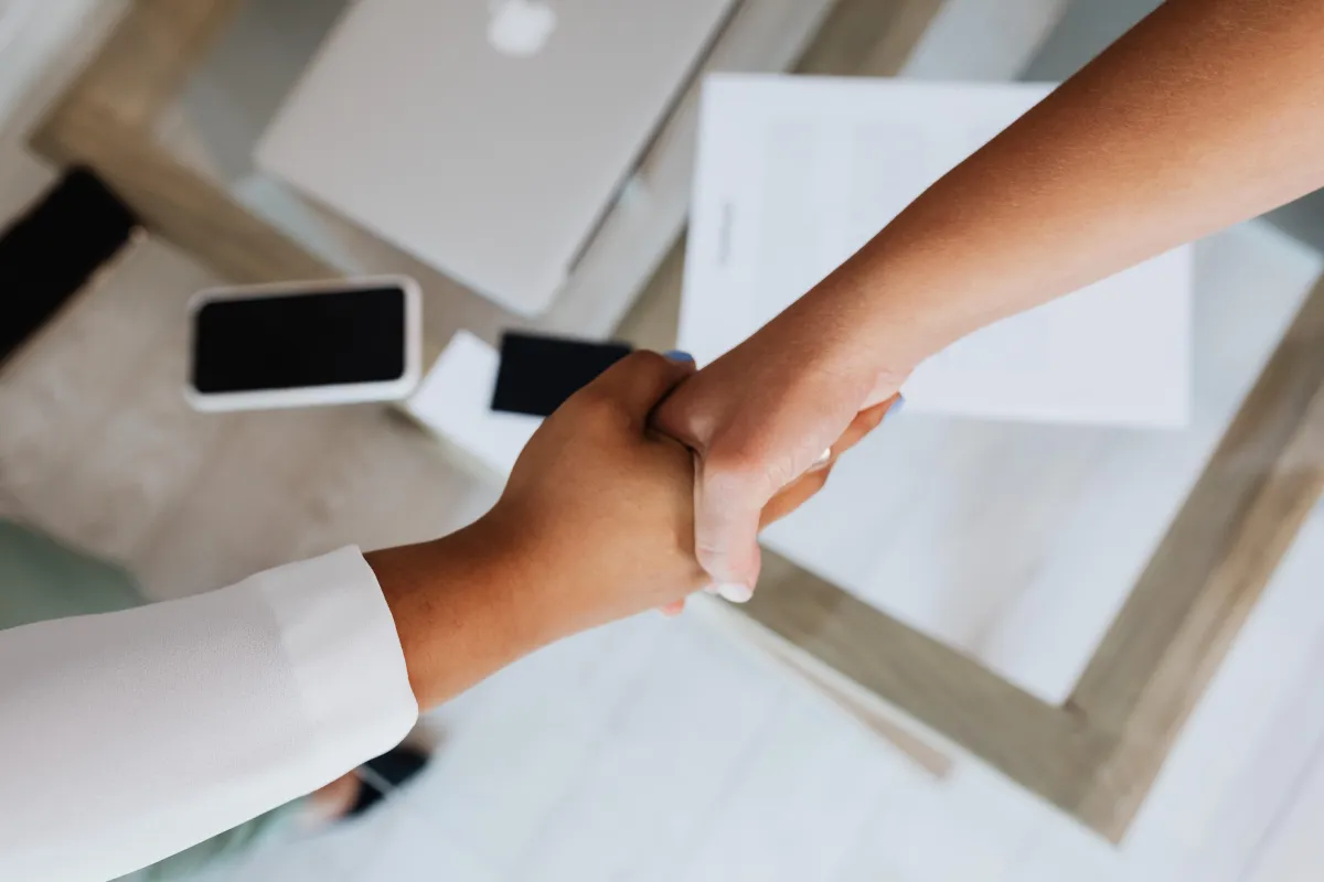 Two women shaking hands