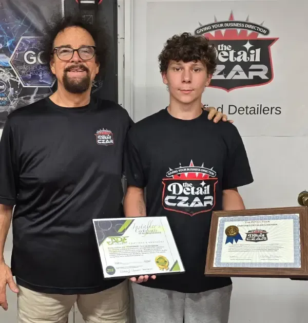 Licensee Hayden Bowling holding 2 Certificates Of Completion with Nick Vacco.