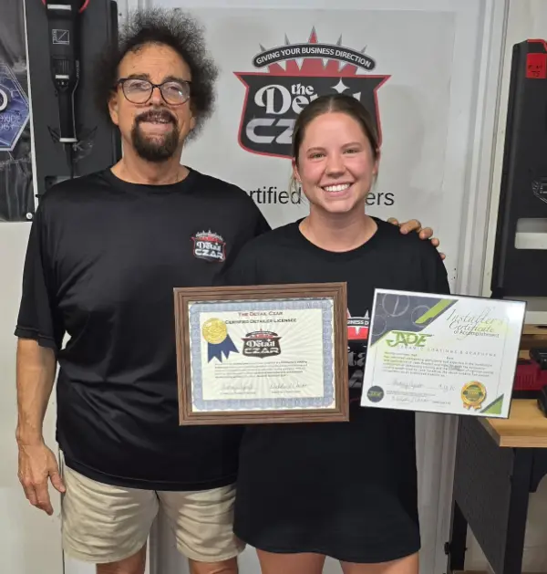 Licensee Audrey Ayers holding 2 Certificates Of Completion with Nick Vacco.