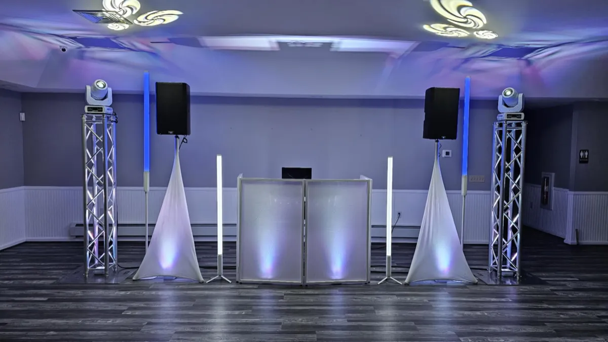 DJ setup with moving head lights on vertical truss