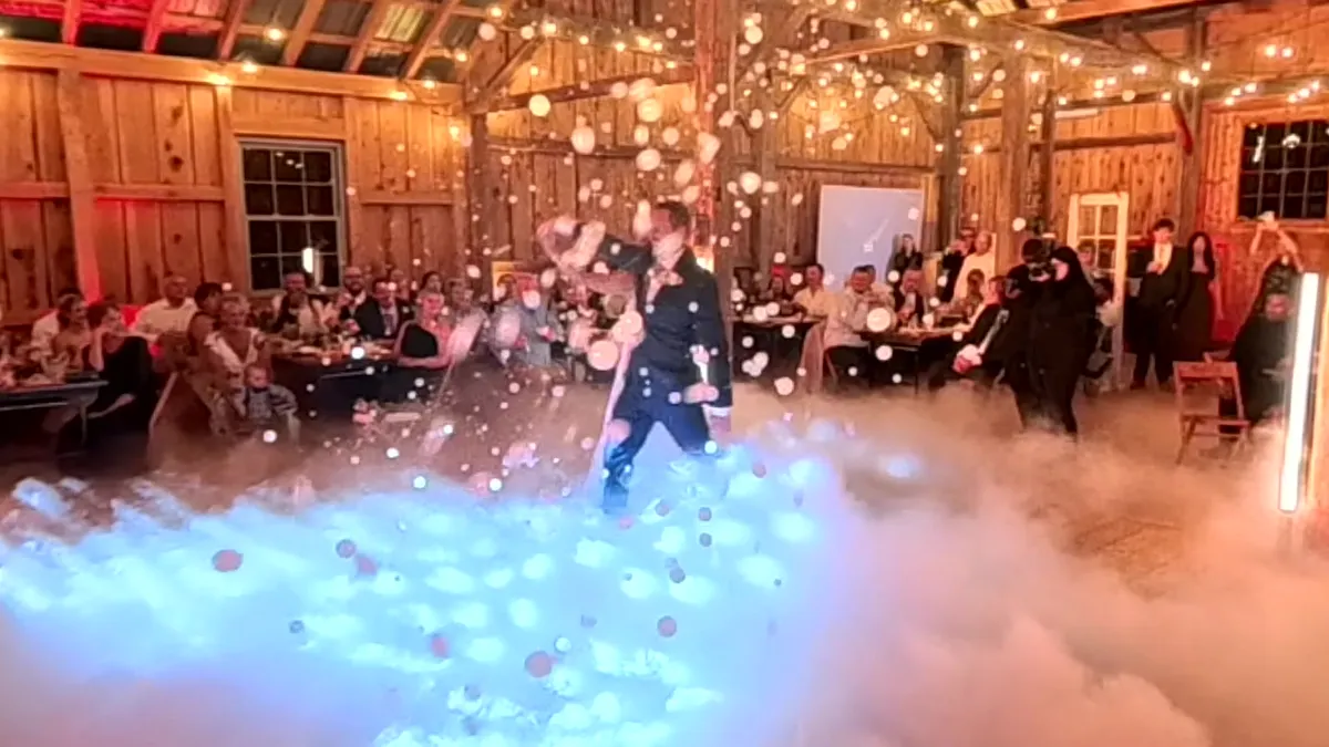 Couple sharing their first dance on a low cloud of dry ice fog