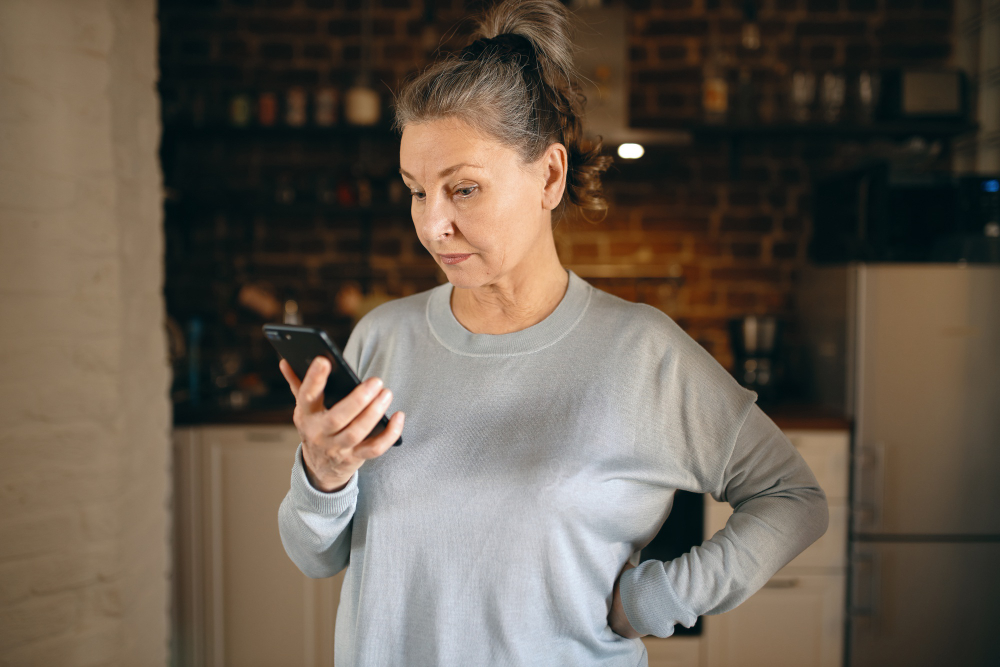 middle aged woman using smartphone at night health search