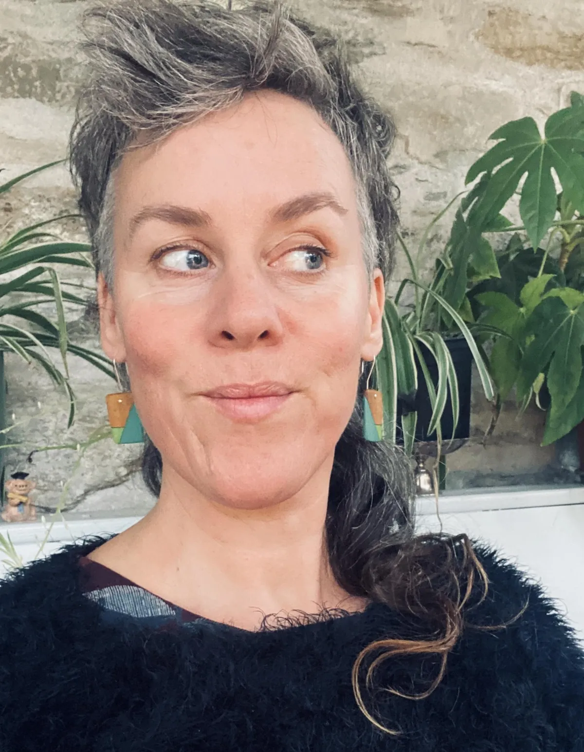 person in blue shorts sitting on beach shore during daytime