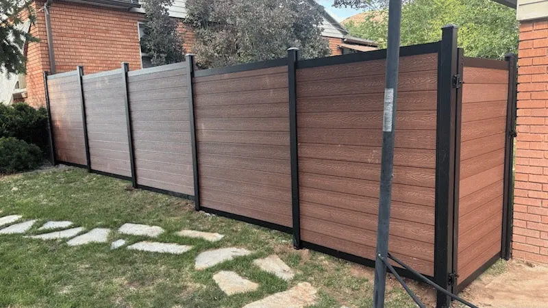 black and brown metal fence with composite slats