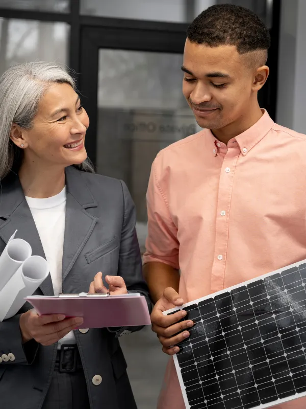 a man is holding a solar panel while woman is showing  report to the man
