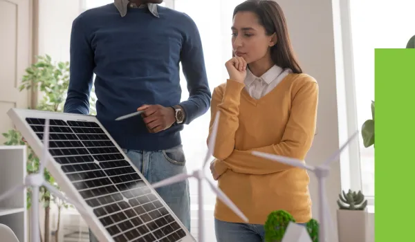 a man teaching a woman about solar panel