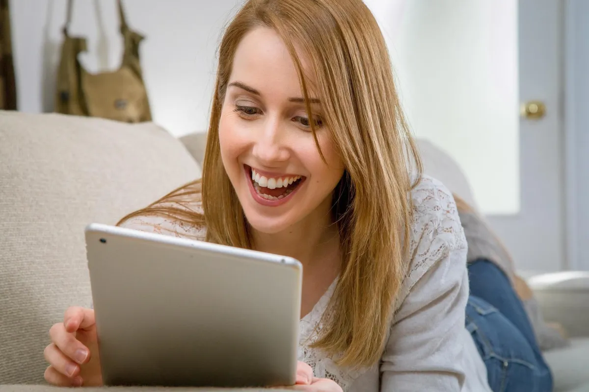 two women talking while looking at laptop computer