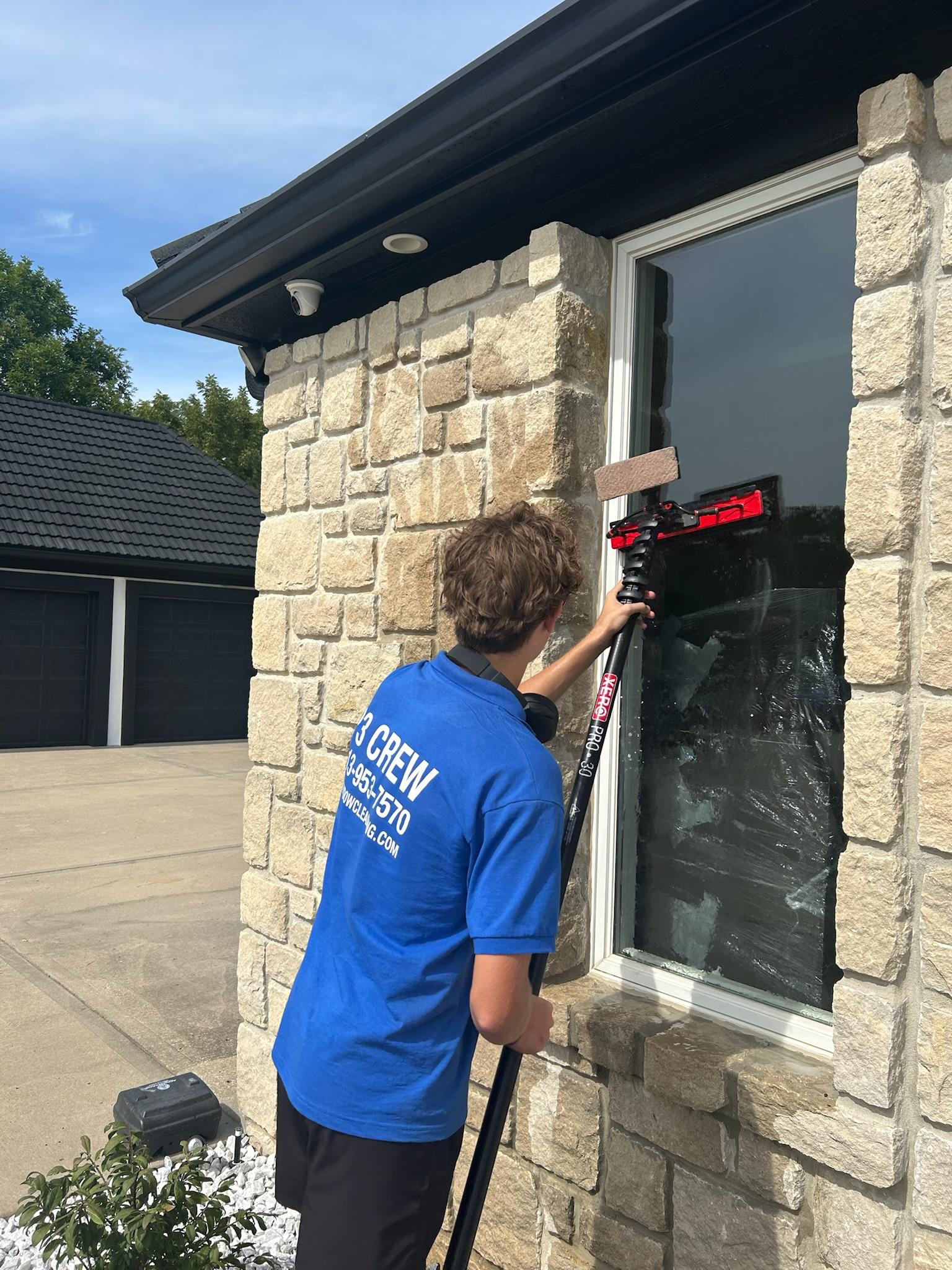 Raindrops obscure a window with a blurry view.