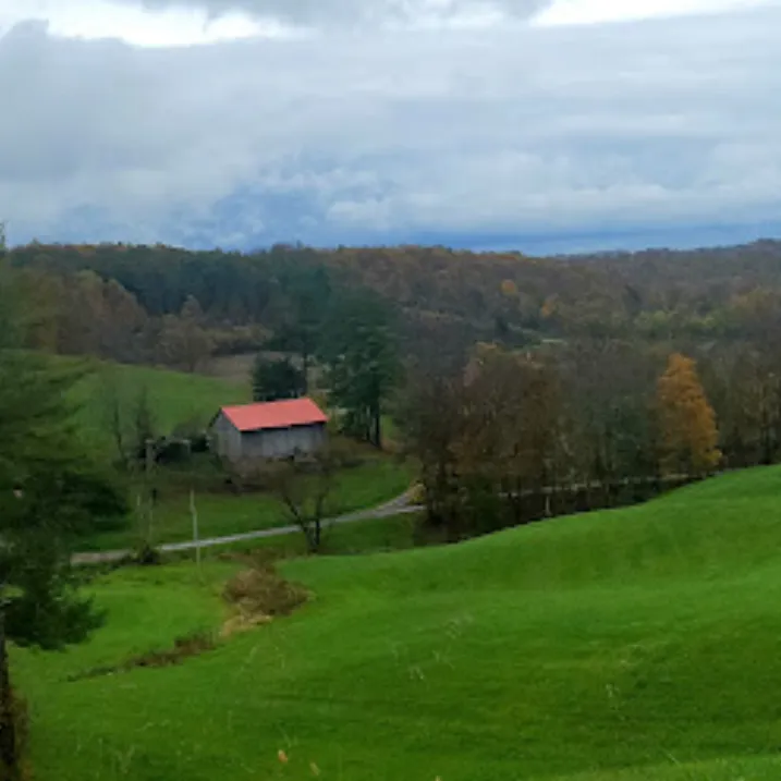 rolling farmland overlooking small house in whipple oh