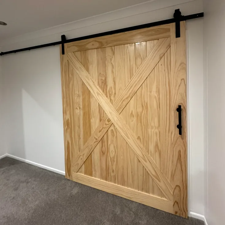 Interior timber sliding barn door installation representing building repair services in Hawke's Bay by Mitch's Maintenance