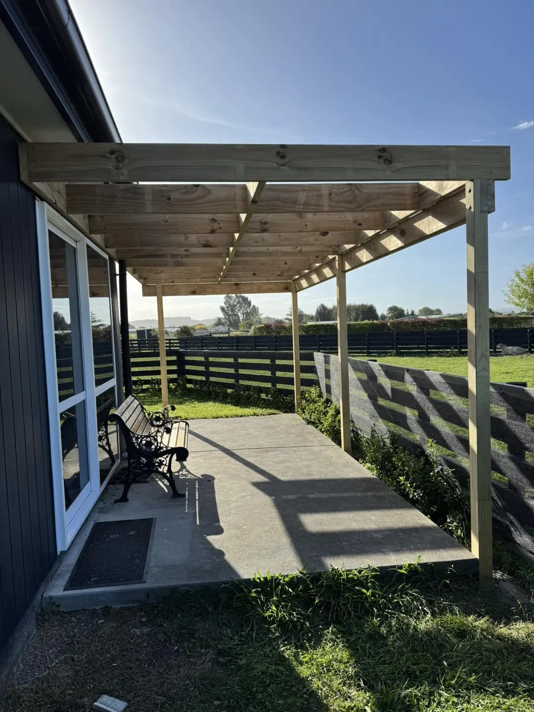 Image of Mitch building a pergola over a deck, showcasing custom pergola installation in Hawke's Bay