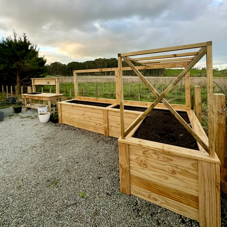 Timber retaining walls and raised planter boxes in garden showing retaining wall and planter box services in Hastings, Hawke's Bay by Mitch's Maintenance