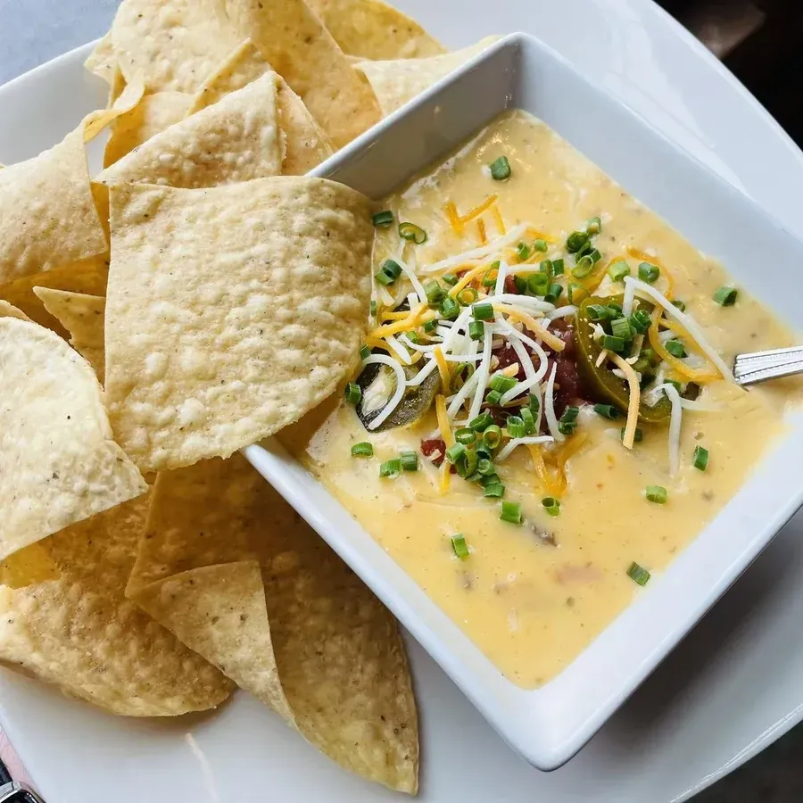 Beer cheese queso dip with jalapenos and pico de gallo served with tortilla chips at Black Cap Brewing Company in Red Lion, PA