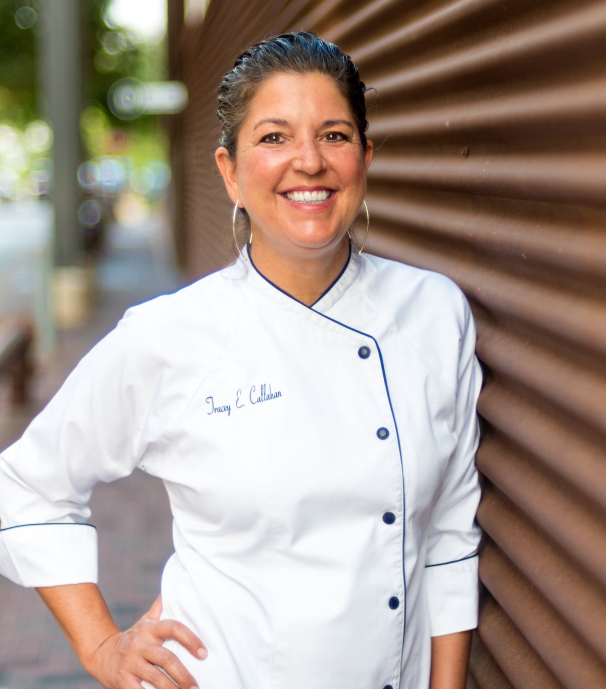 A diverse family of four, parents and two children, laughing together on a sunlit living room couch. The scene is modern, airy, and warm, with soft neutral tones and playful accents. Everyone is engaged and joyful, radiating connection and happiness.