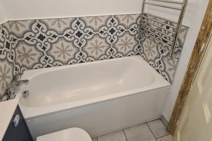 Tile contractor in Staple Hill tiling a bathroom wall