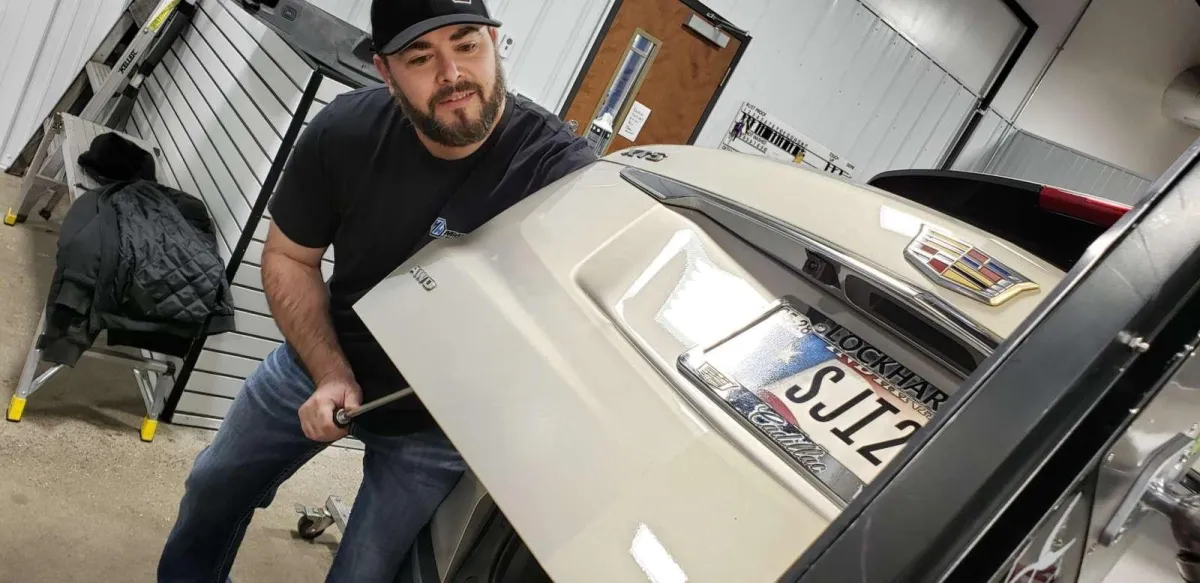 Indianapolis Auto Spa PDR Technician at Work Repairing a Dent on a Cadillac