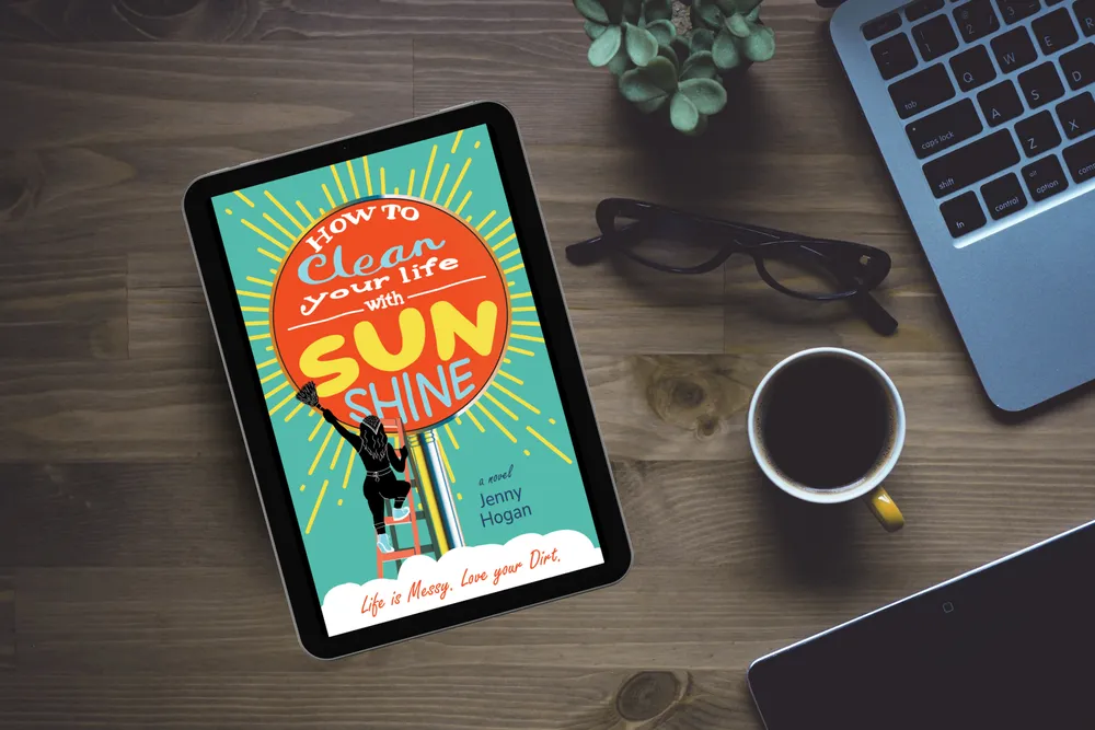 an ipad on a desk that features the book cover for "How To Clean Your Life With Sunshine" a novel by Jenny Hogan