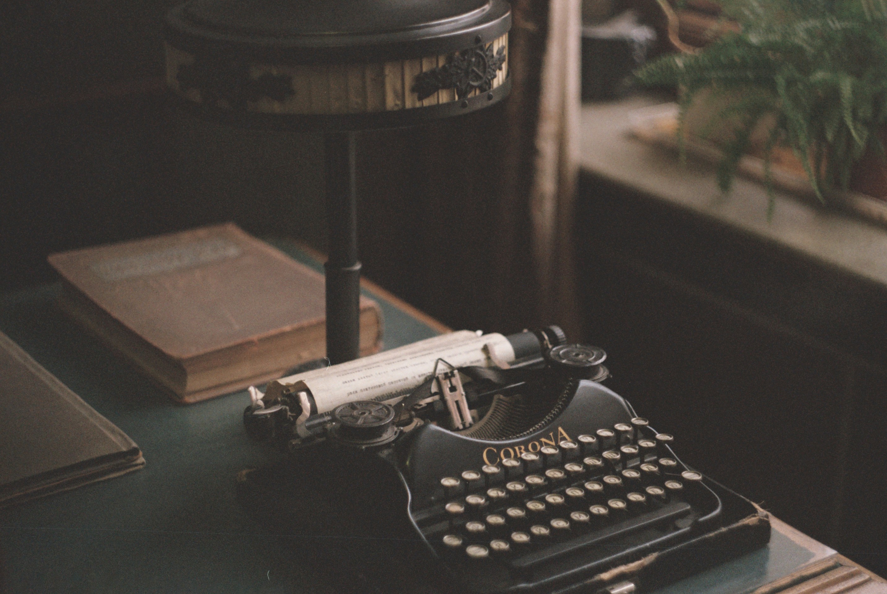 An old Corona typewriter mid-story, paper in the carriage, ready for the next line