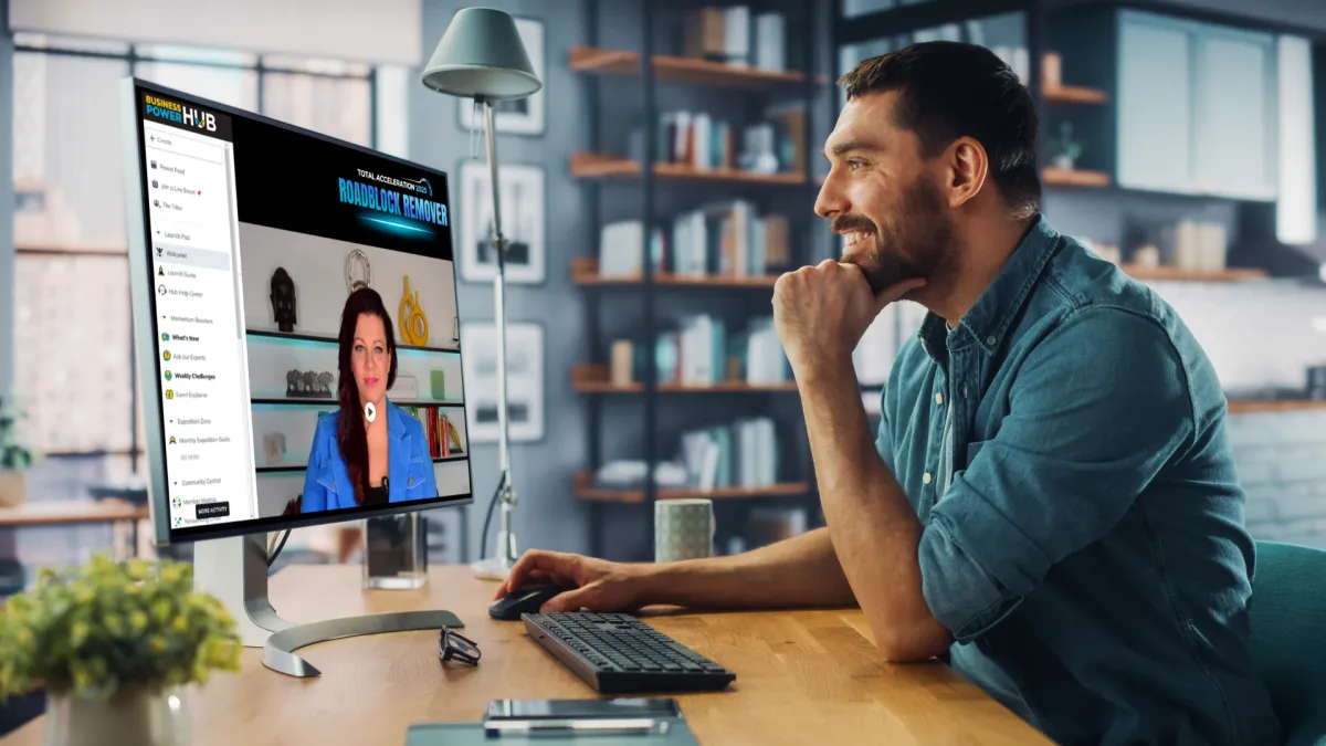 Man watching a webinar on his computer featuring Claire Ansell presenting the Roadblock Remover session in the Business Power Hub.