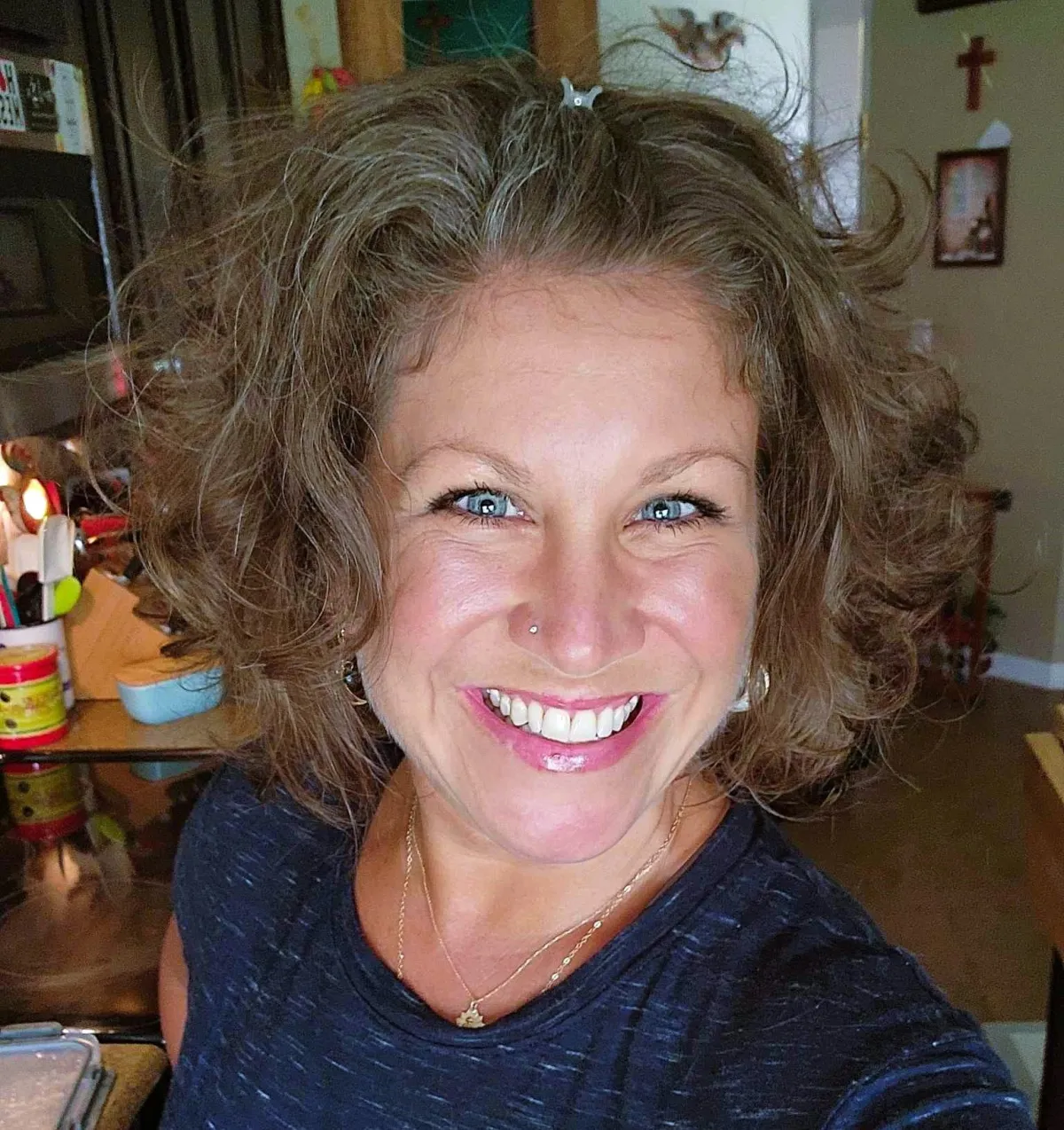 Stacy smiling in a blue shirt, holistic wellness educator for busy moms