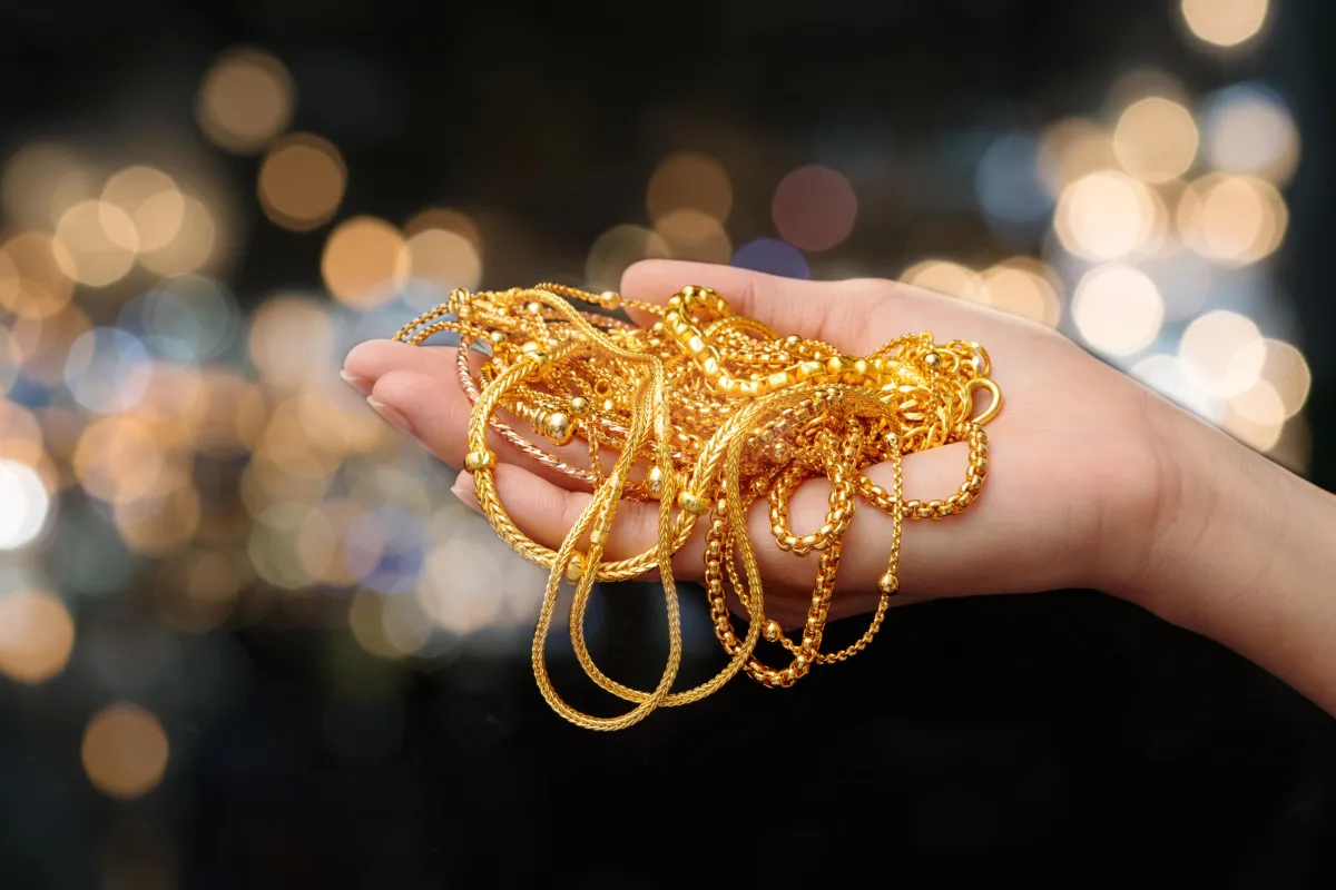 A white ring box with a gold wedding band