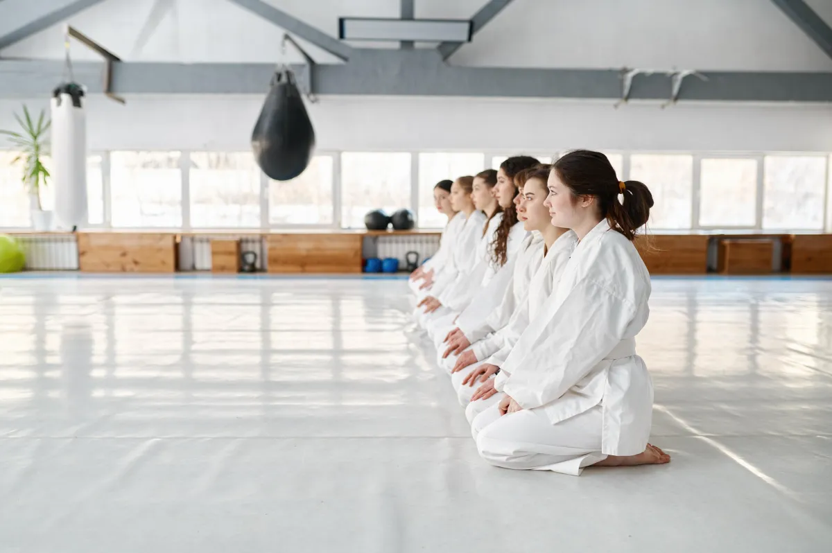 young-aikido-students-wearing-kimono-sitting