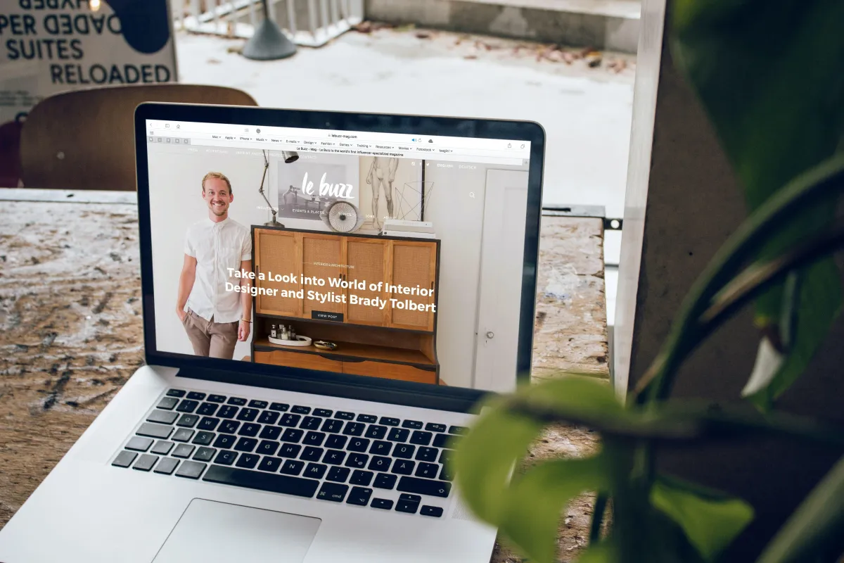 A laptop is placed on the table where a website is opened on the screen