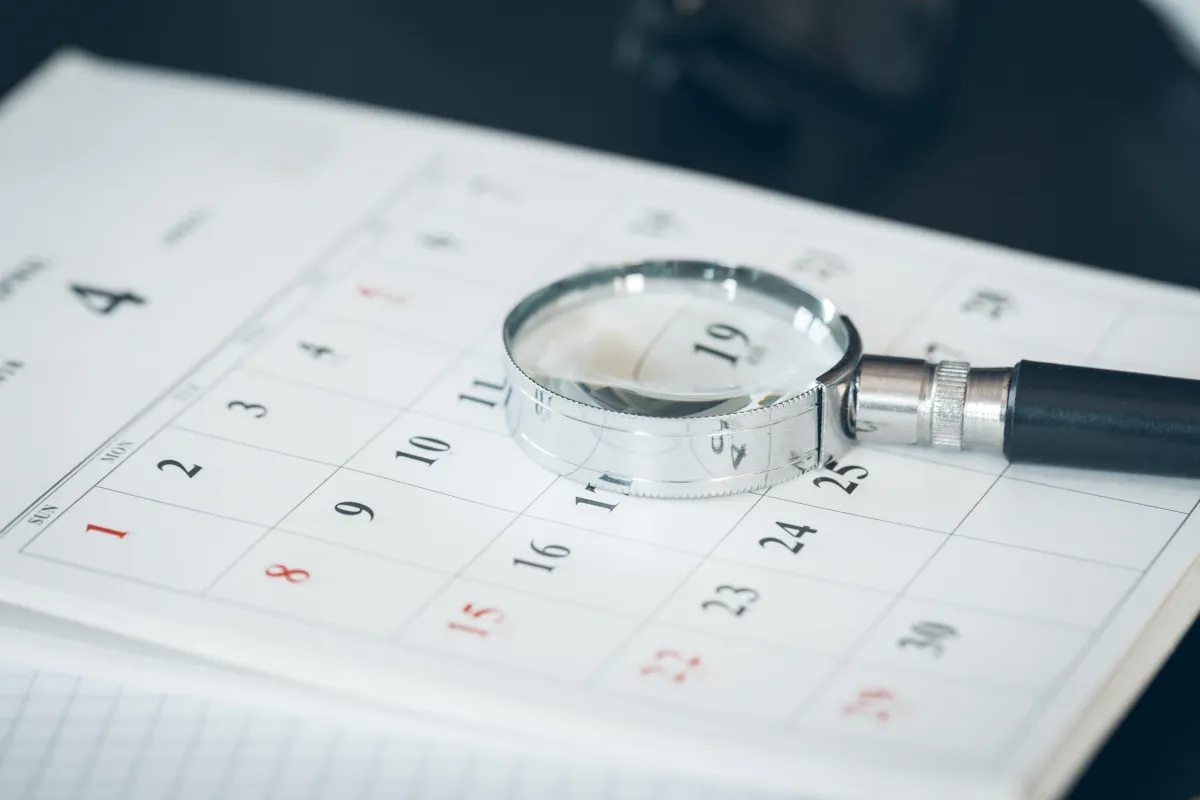 A magnifying glass is placed on top the calendar