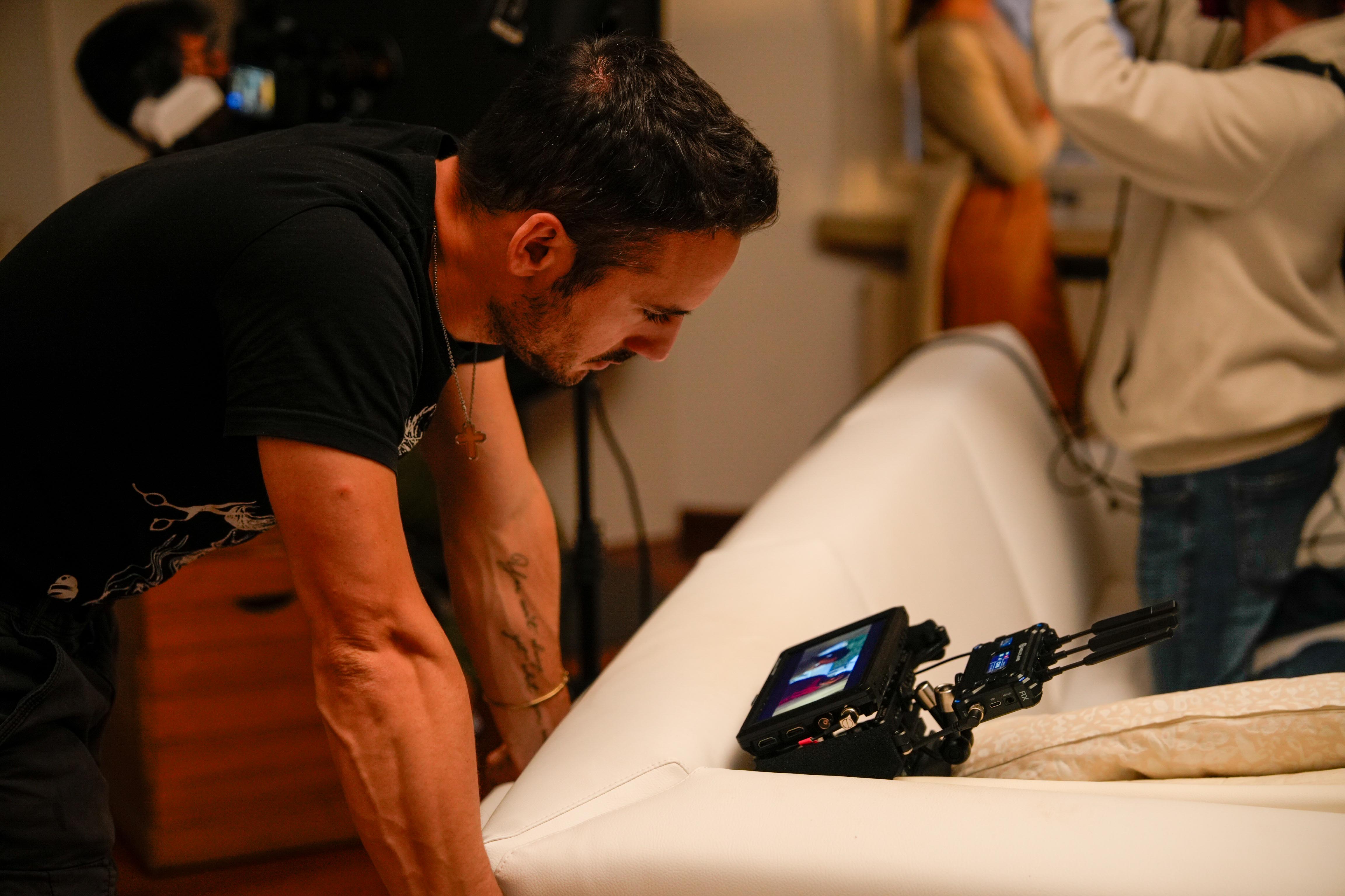andrea joshua asnicar filmmaker looking at monitor during Sangue Non È Acqua filming 