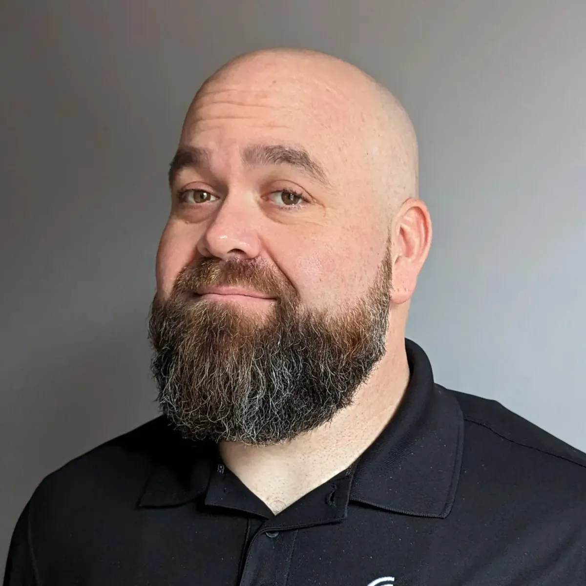 Professional headshot of Matthew Hoog, smiling warmly, against a neutral background