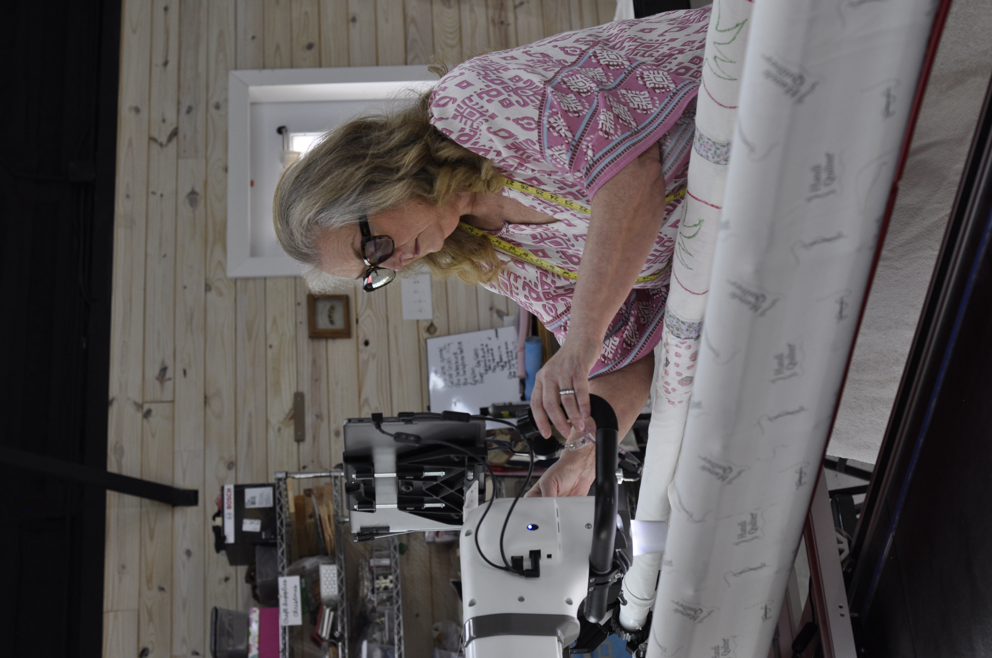 Robin working in her studio, applying her methodology to a memory quilt