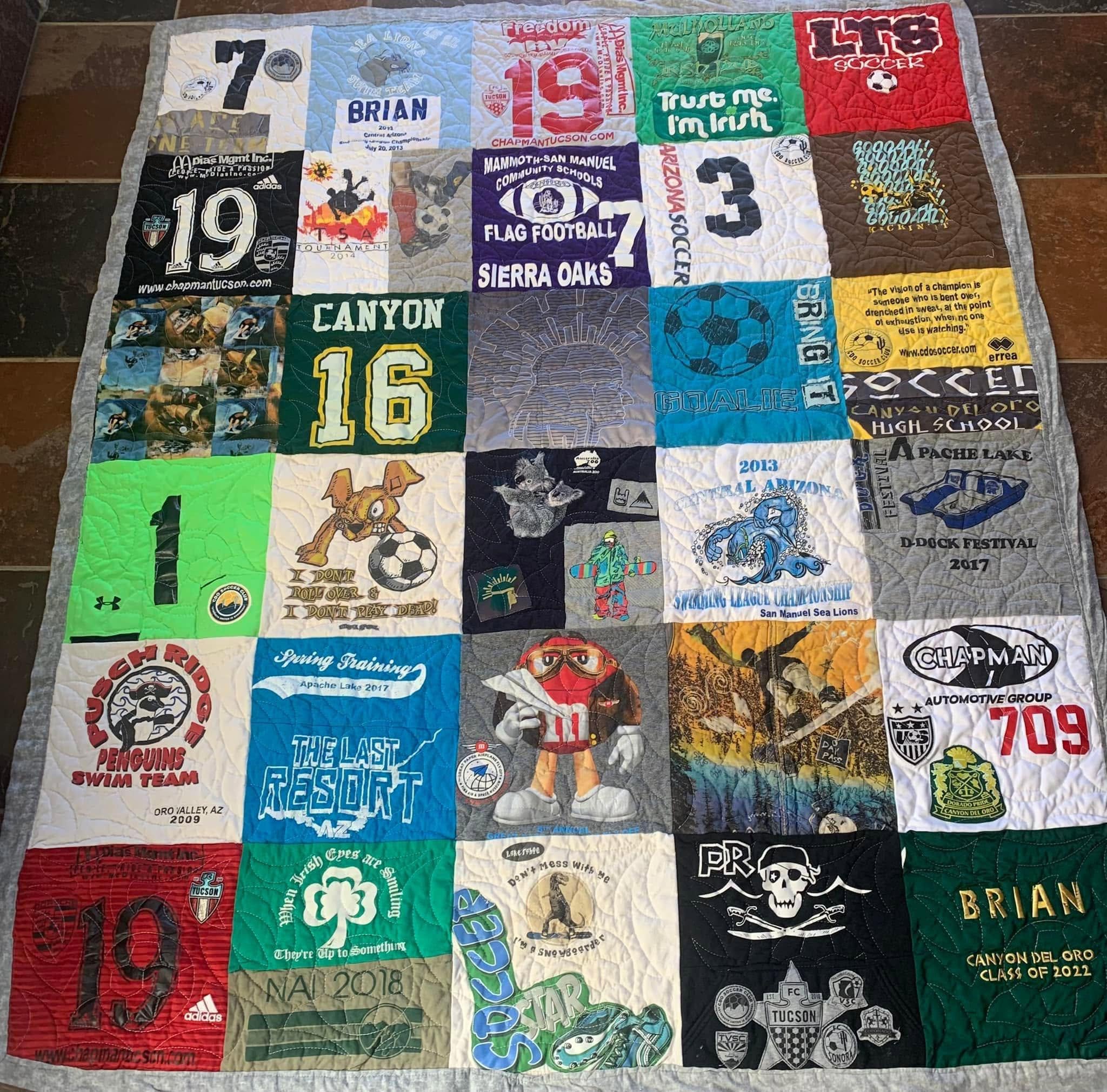 A memory quilt featuring graduation clothing and memorable pieces.