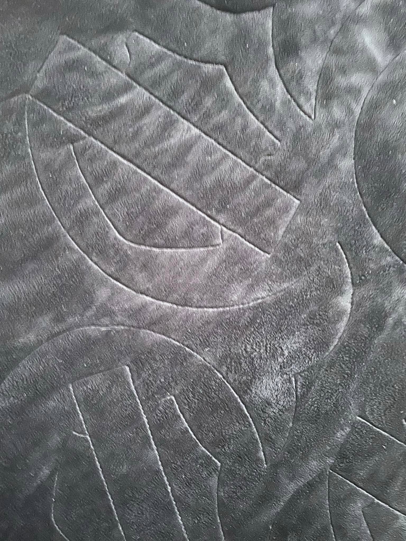 Detailed stitching on a memory quilt piece by piece.