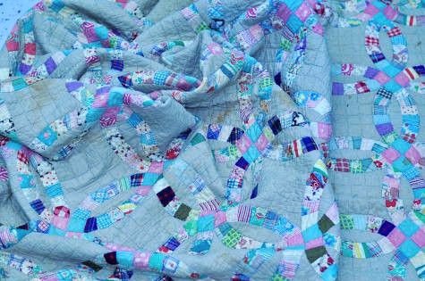 Close-up of intricate stitching on a nostalgic double wedding ring quilt