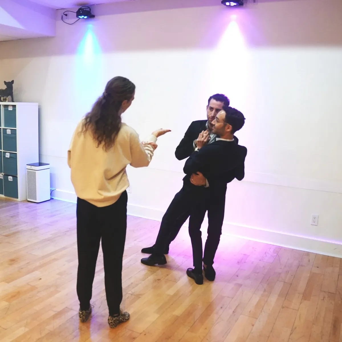 a man and woman dancing in a room with tables and chairs