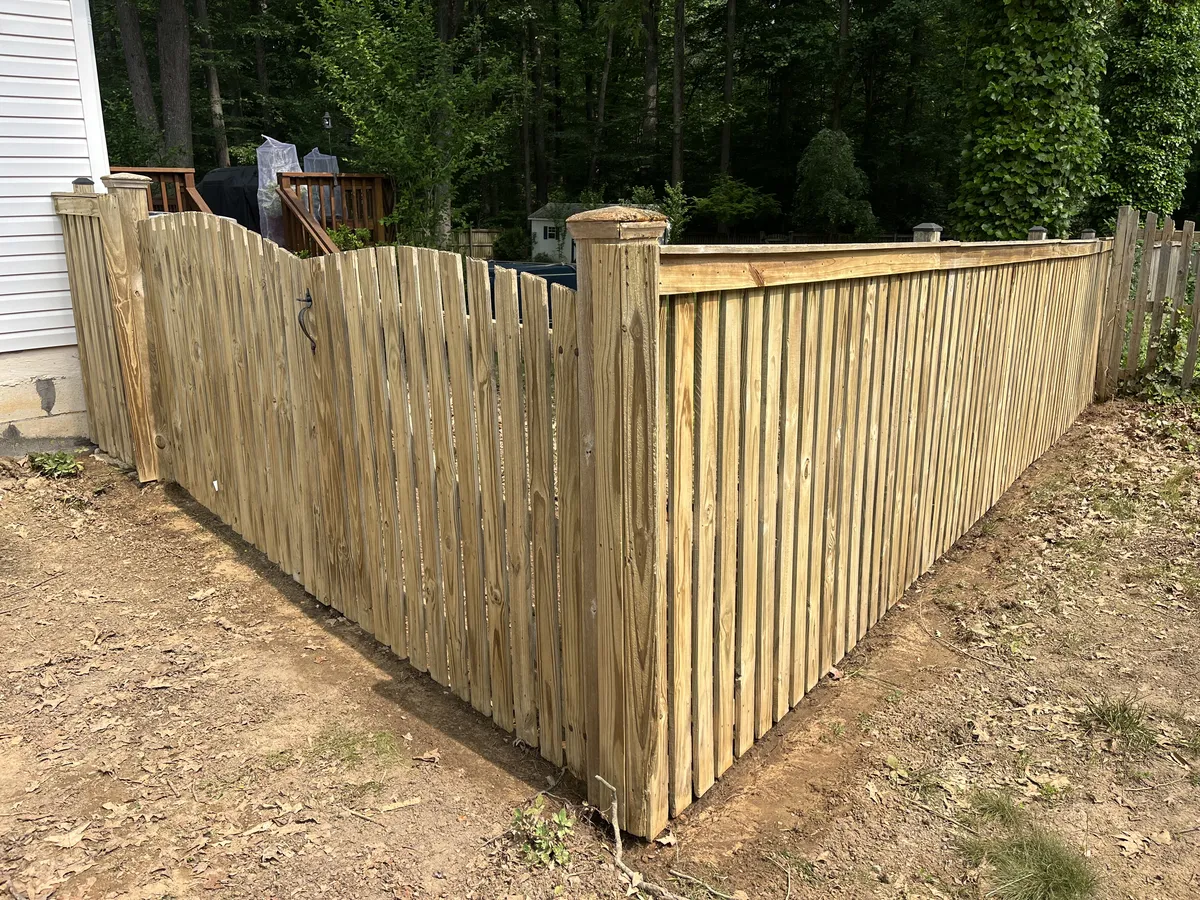 Professional soft washing fence cleaning service removing mold from wood fence in Lakeland Florida