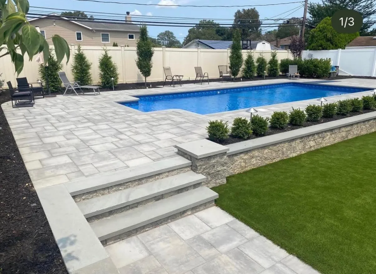 Seamless integration of a high-end masonry patio meeting a luxury pool edge