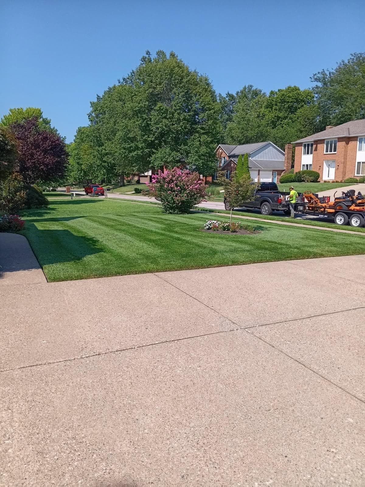 Freshly mowed front yard with clean lawn stripes and maintained landscape beds by Earl’s Lawn Service in Independence, Kentucky.