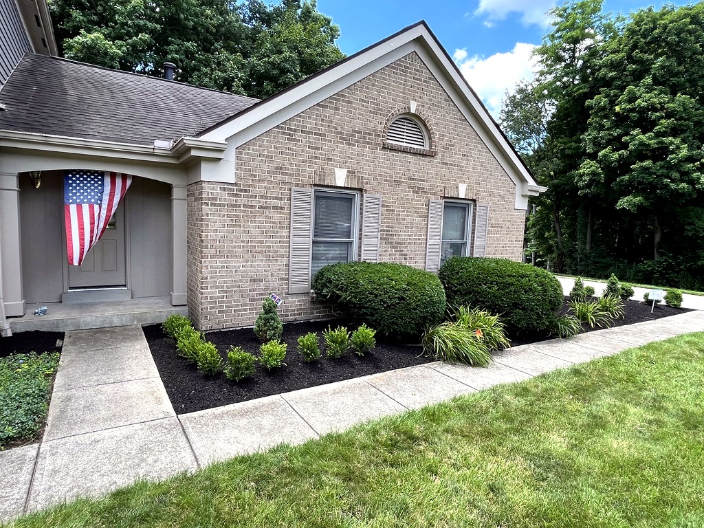 Fresh black mulch, trimmed shrubs, and landscape bed cleanup along the front of a Northern Kentucky home