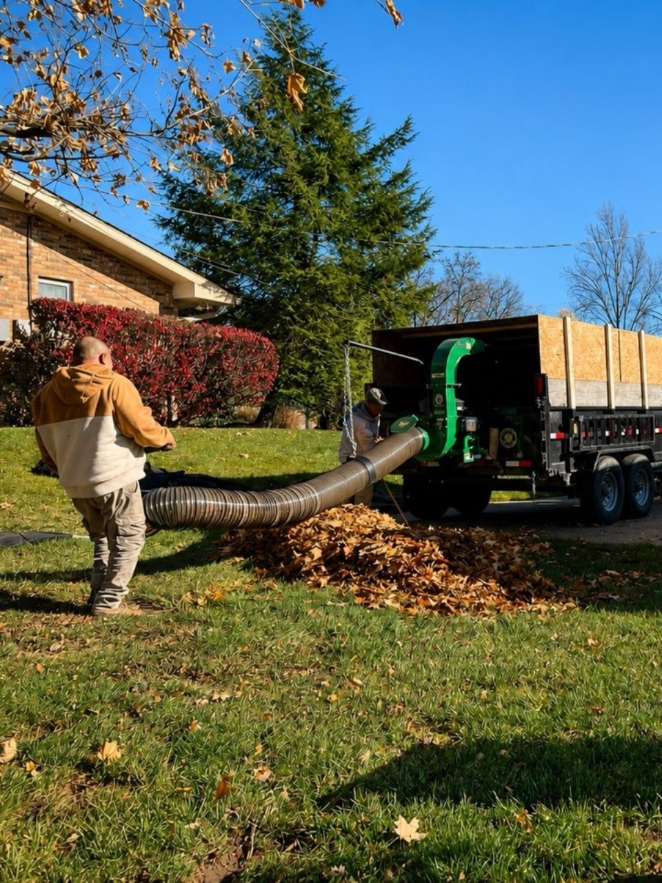 Earl’s Lawn Service crew using leaf removal equipment for seasonal property cleanup in Northern Kentucky