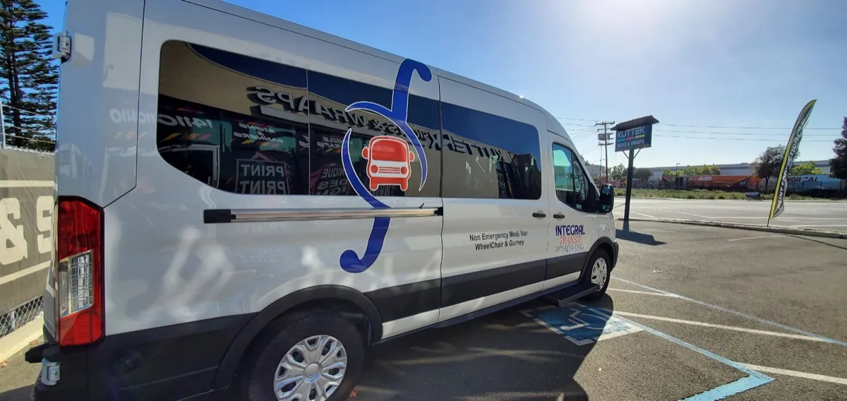 Integral Transit van with the blue and red integral logo, labeled Non Emergency Medi Van, Wheelchair and Gurney
