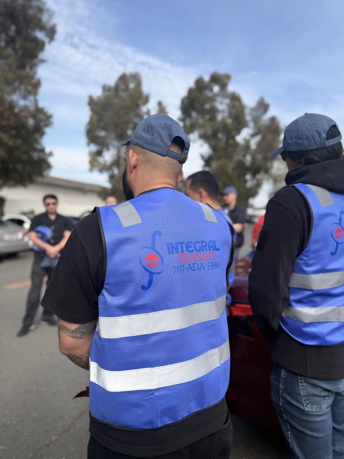 Integral Transit team members wearing blue Integral Transit safety vests