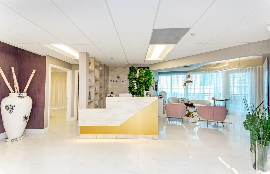 woman signing on white printer paper beside woman about to touch the documents