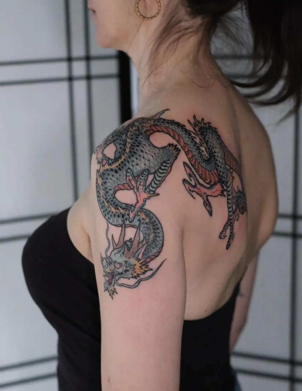 person in blue denim shorts and white nike sneakers standing on gray concrete floor