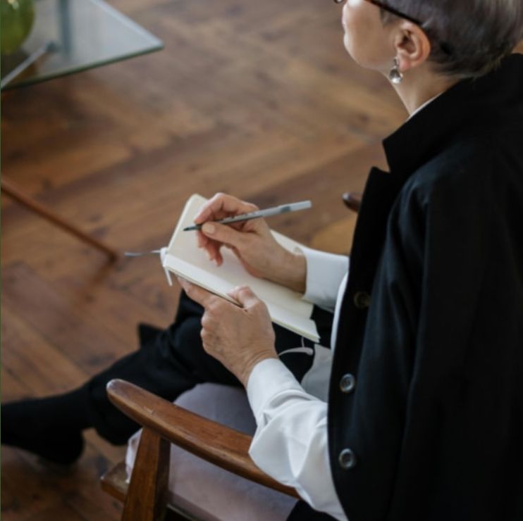 a woman journaling i a notebook