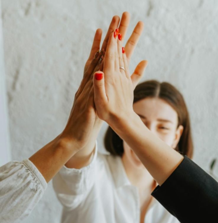 Hands ofif three people doing a "high five"
