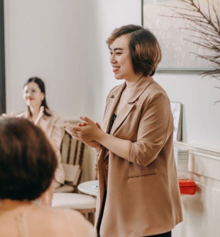 Woman standing up speaking to group