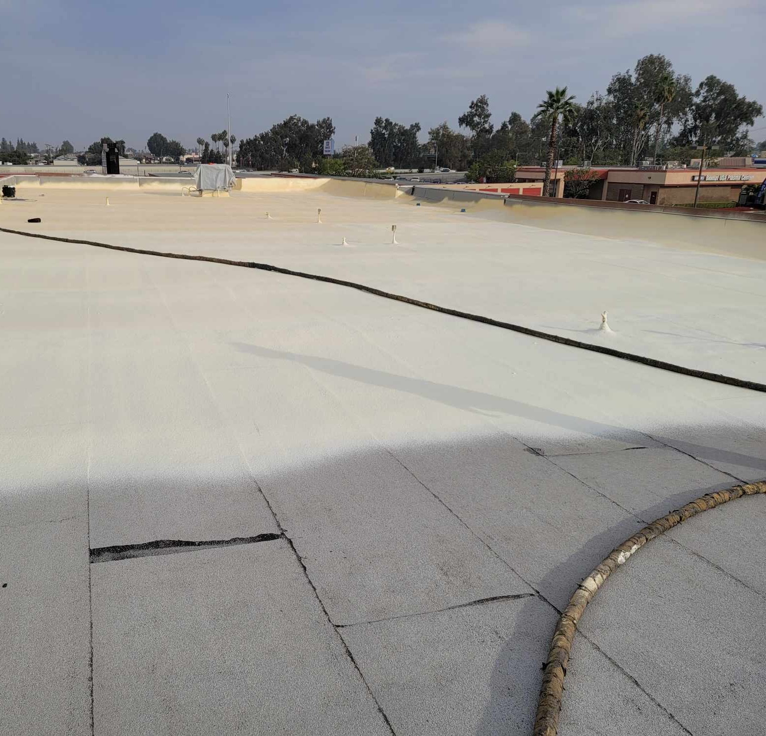 Spray foam roofing being applied to a residential roof in Bakersfield
