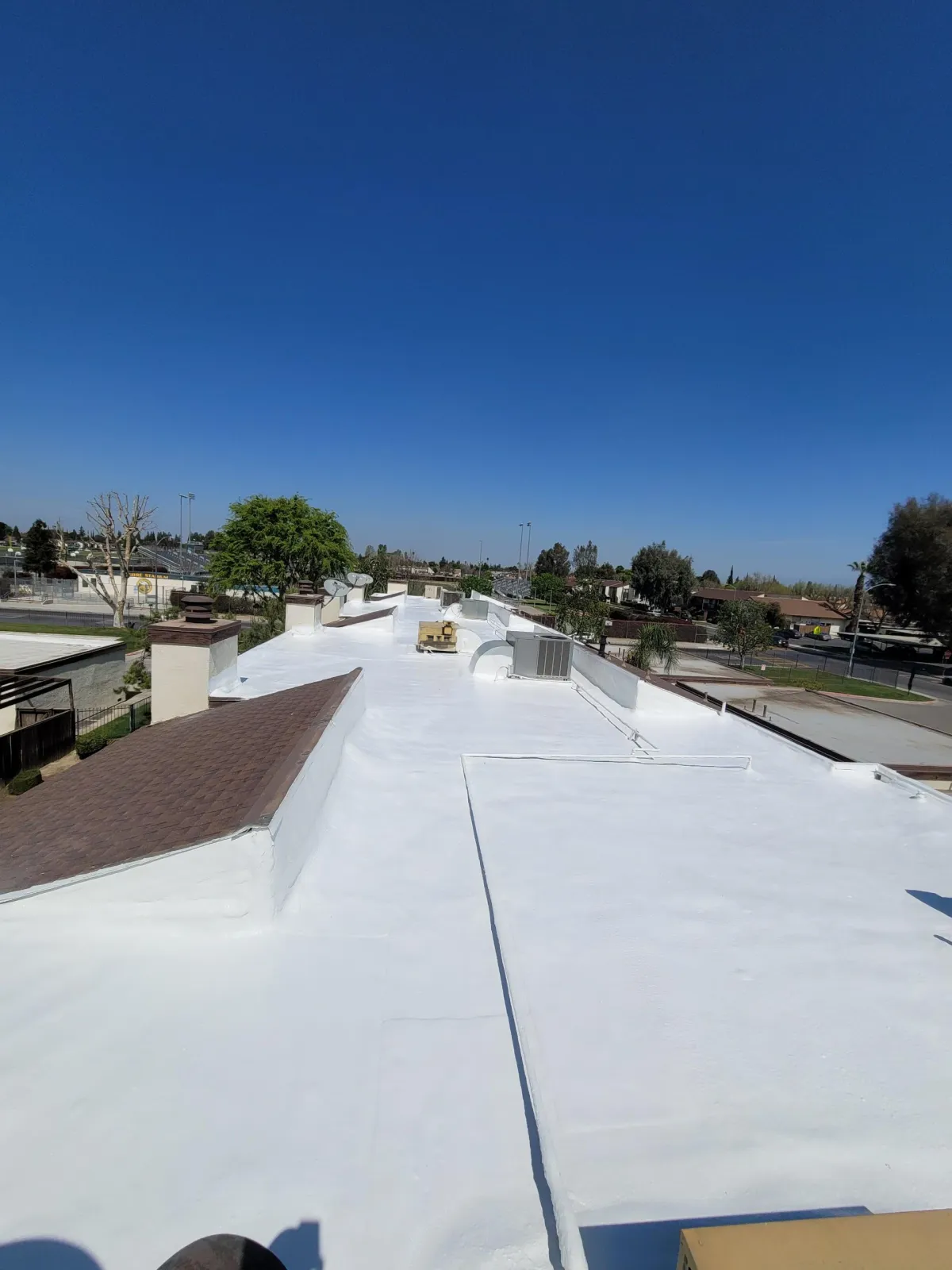 Silicone coated commercial roof in Bakersfield CA providing heat and waterproof protection