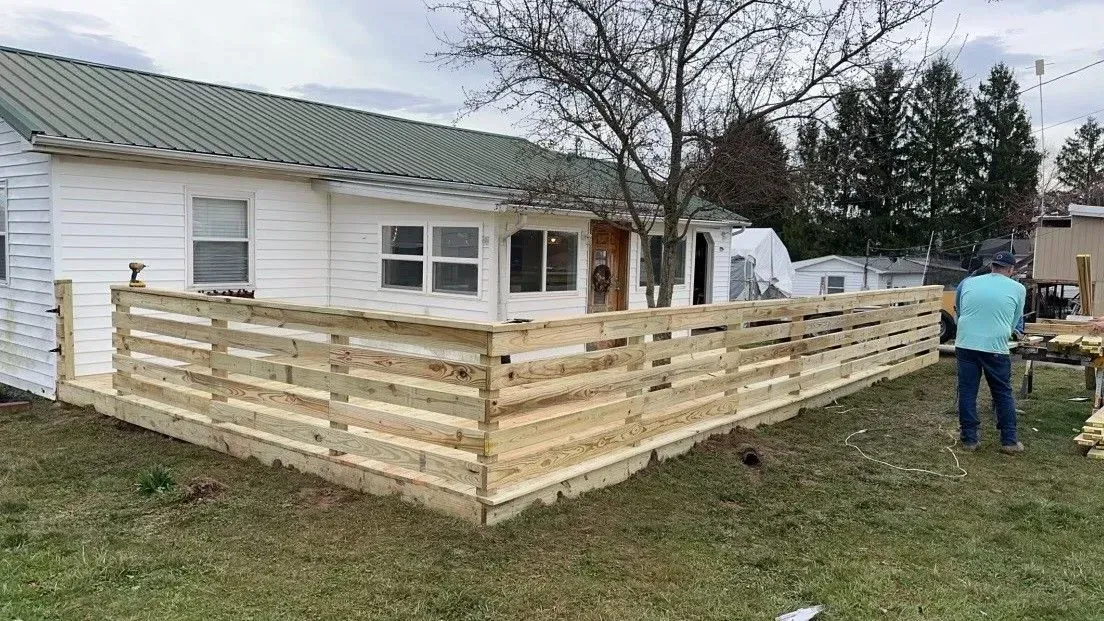 Completed residential driveway and site grading by RidgeForge Construction in warm late-afternoon light.